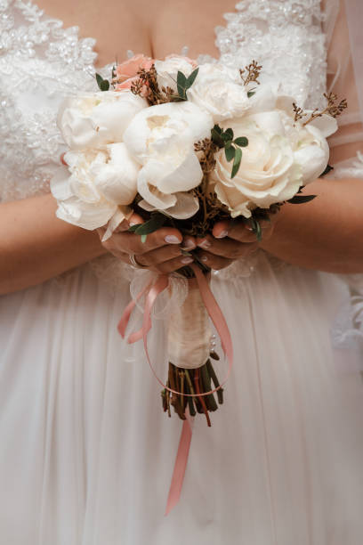 istock delicate wedding bouquet in the hands of the bride 1372339430