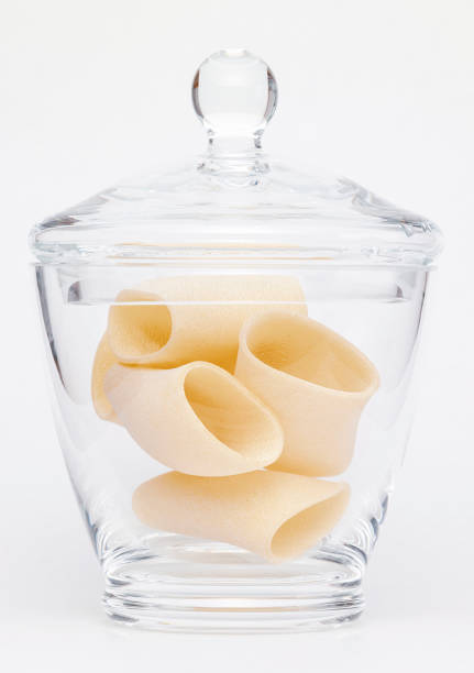 Pasta in glass jar on a white background
