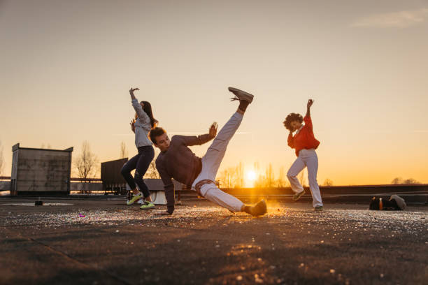 istock Young man and women doing break dance on roof 1372340945
