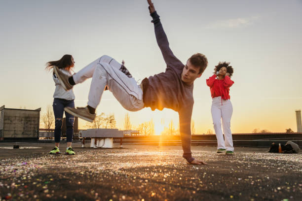 istock Young man and women doing break dance on roof 1372341014