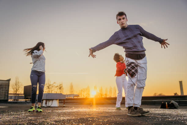istock Young man and women doing break dance on roof 1372341026