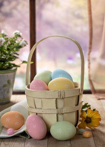 istock Colorful easter eggs in a basket by a window 1372341159