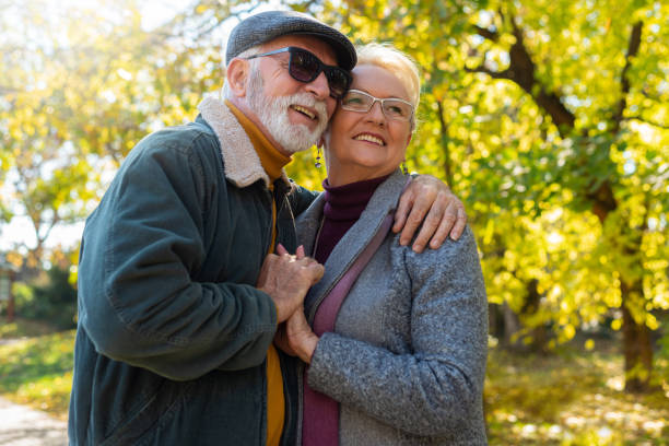 istock Elderly couple relaxing in park 1372341356
