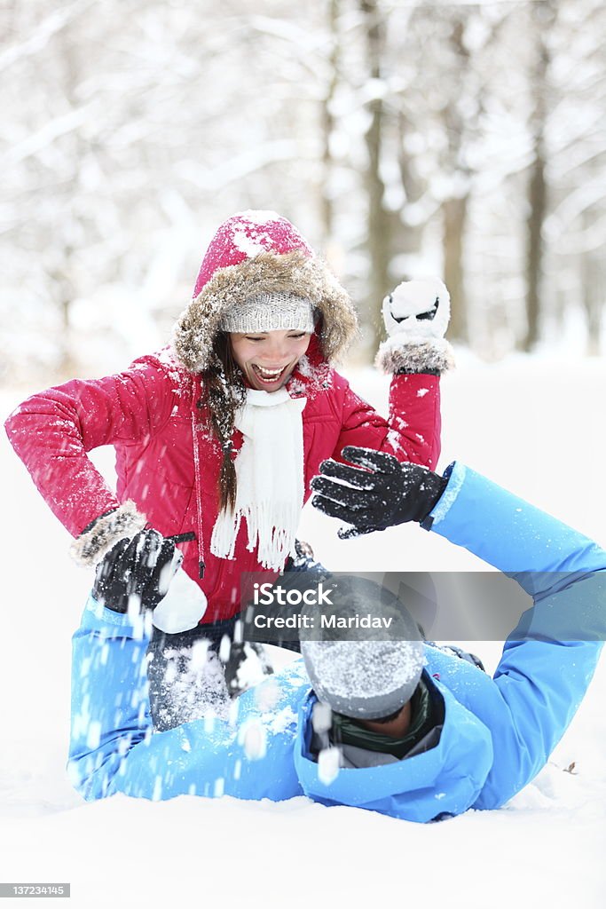 winter couple snowball fight Winter couple snowball fight. Young couple having fun in snow outside. young couple in their twenties. 20-29 Years Stock Photo