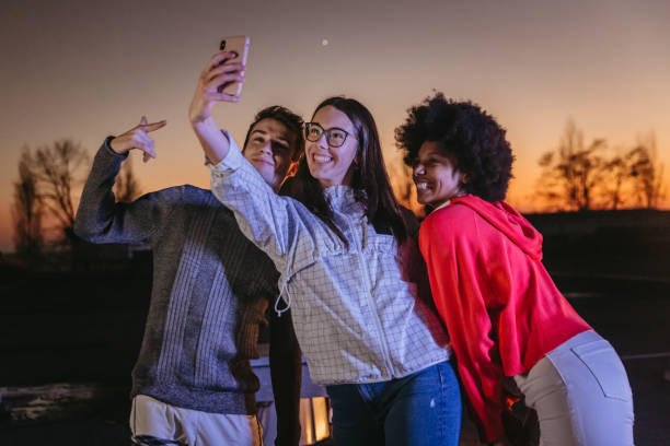 istock Friends taking selfie with friends on rooftop 1372341473