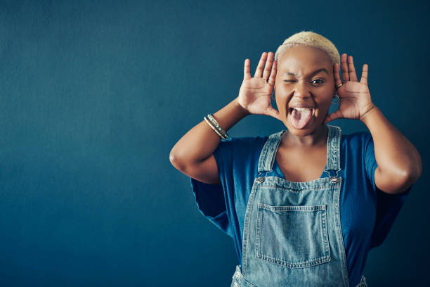istock Young woman making a face in front of a blue background 1372342514