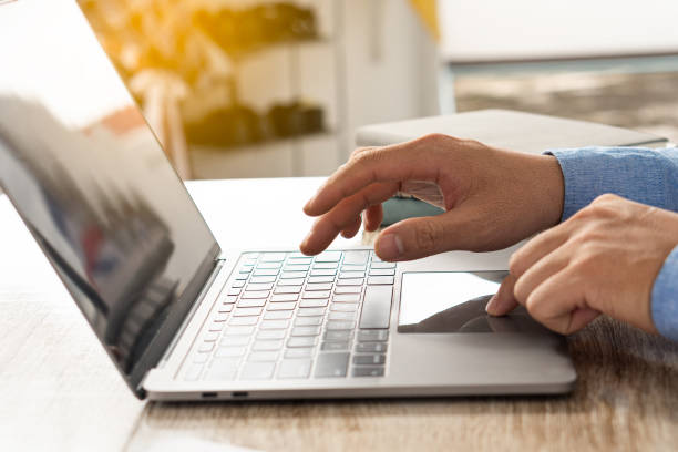 istock Hand typing keyboard manager working on the project in open space office Documents and laptop on the table 1372342747
