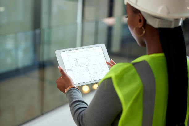 istock Rearview shot of an unrecognizable female architect using a tablet while standing in her office 1372342922