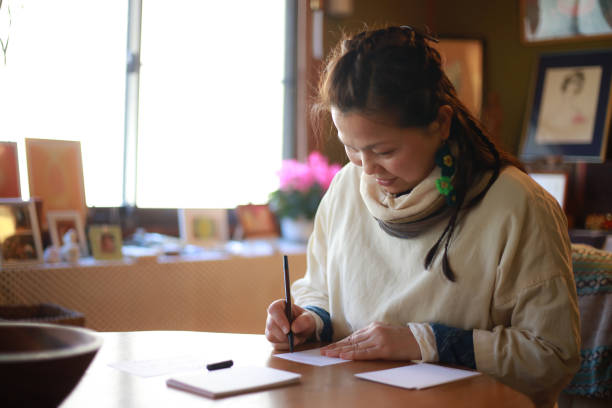 istock Female writing a New Year's card 1372343045