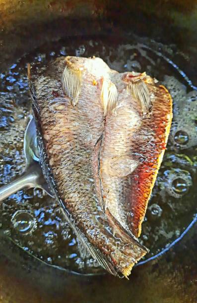 istock Fried Dried Snakehead Fish on ladle - food preparation. 1372343199
