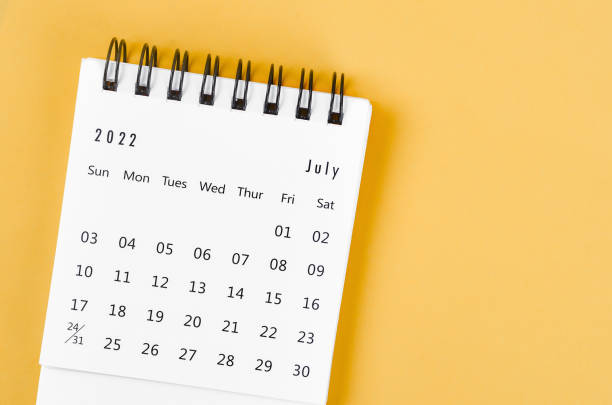 istock July 2022 desk calendar on light yellow background. 1372344028