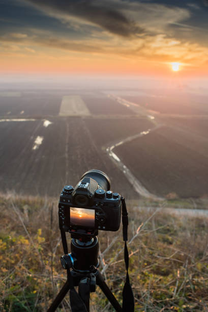 istock Sunset photography. Camera with tripod Sunset. 1372345107