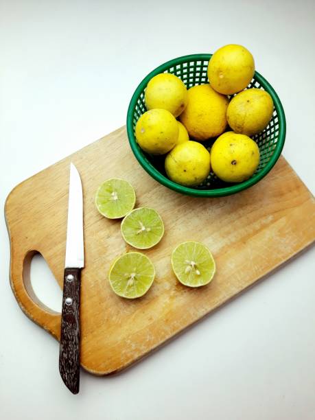 Cutting Fresh Lemon on cutting board - food preparation.