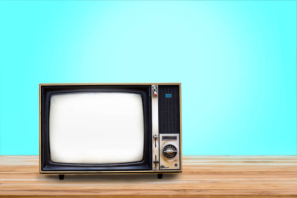 istock Retro old television receiver on wooden table with light blue gradient background. Vintage old TV filter photo 1372345326