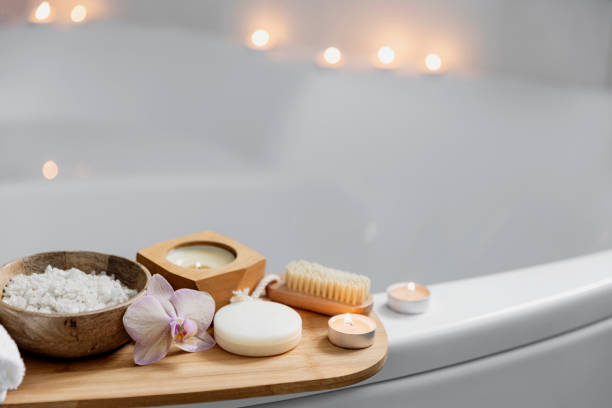 istock Hotel spa treatment or home bath procedure. Bathroom with accessories on tray 1372348305