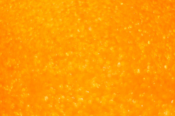 istock Orange background with highlights and bokeh and place for text. 1372348882