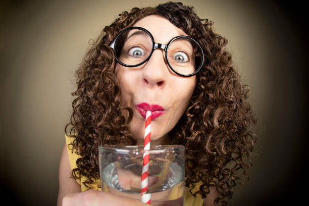 Funny Fisheye Lady Drinking Water From A Paper Straw A fisheye image of a funny woman drinking water though a paper straw. drinking straw funny stock pictures, royalty-free photos & images
