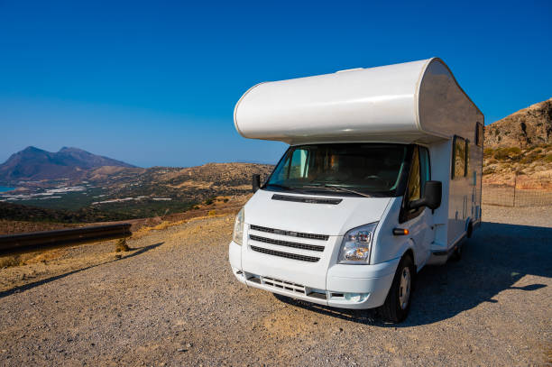Motorhome RV parked on the side of the road, Crete, Greece. Motorhome RV parked on the side of the road, Crete, Greece. Travelers with camper van are resting on an active family vacation with view over Falasarna beach western Crete, Crete, Greece. RV truck stock pictures, royalty-free photos & images