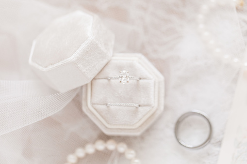 White Gold Diamond Wedding Rings in a Velvet Ring Box in Bright Natural Light.