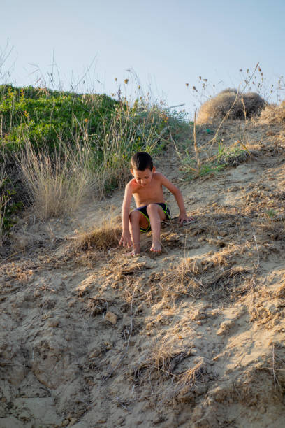istock Little boy playing in the sand 1372350342