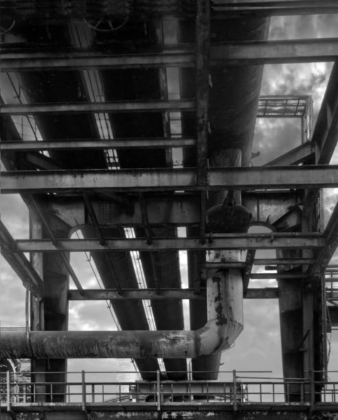 istock Pipe bridge with thick metal pipes, abstract view from below, black and white 1372351044