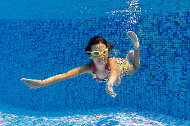istock Happy smiling underwater child in swimming pool 137235149