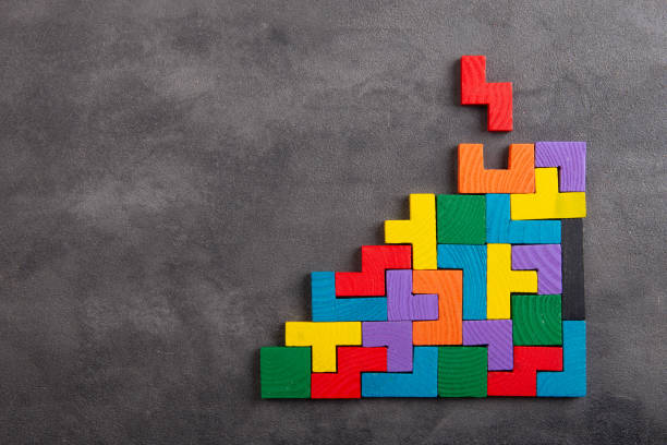 istock Creative idea solution - business concept, jigsaw puzzle on the grey background. Leadership and teamwork strategy success. 1372351749