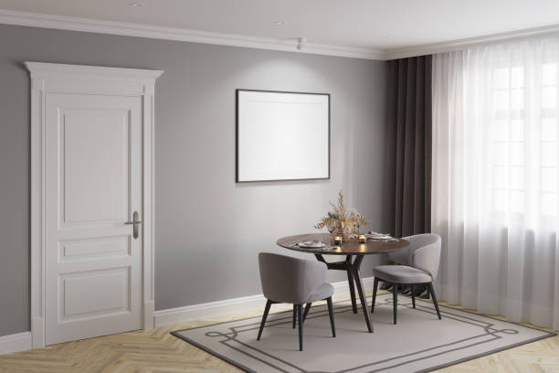 istock A gray modern classic dining room with a blank illuminated horizontal poster above a round wooden table with two elegant chairs, a white classic door, dark gray curtains near the window. 1372352539