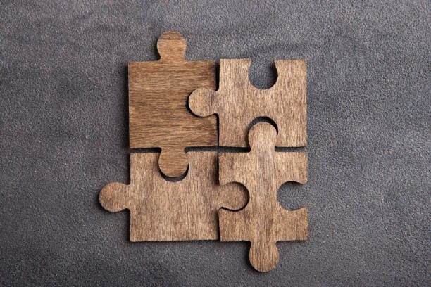 istock Creative idea and solve the problem concept. Teamwork success strategy - wooden puzzle on the grey background 1372352766