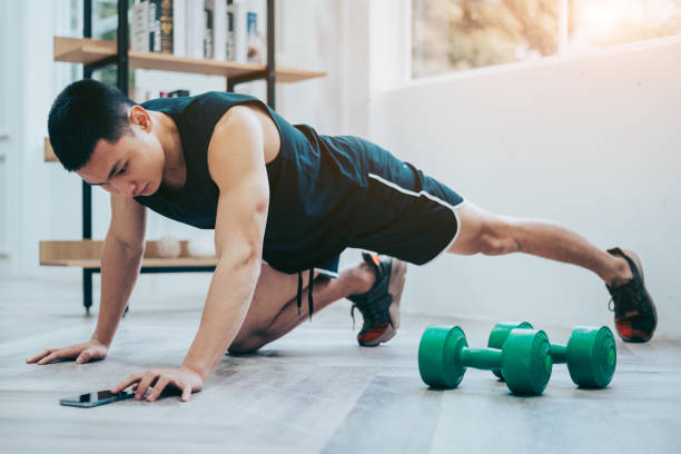 istock Young Asian man exercise at home 1372353201