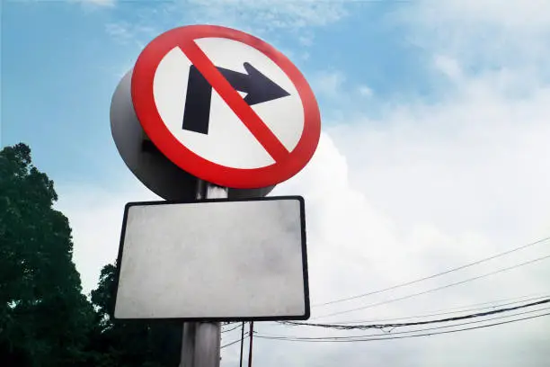 Photo of traffic sign board no turning right with a blank board underneath