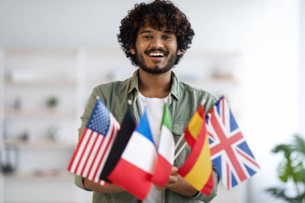 istock Cheerful indian guy holding bunch of flags 1372359493