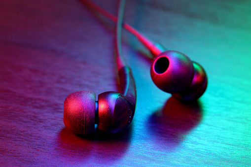 Headphones in multicolor abstract lighting.