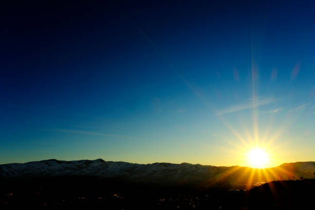 Sunstar golden sunlight at sunset or sunrise in beautiful blue sky