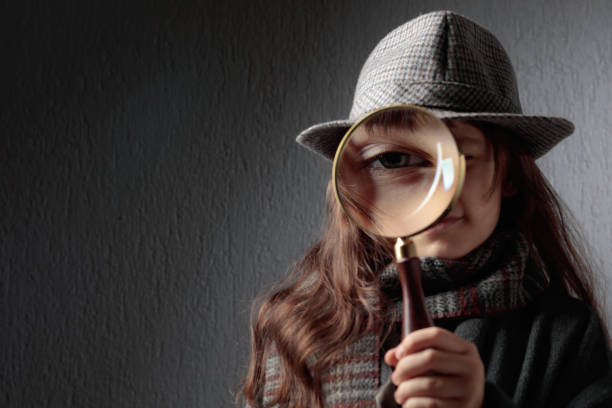 istock Cute little detective with a magnifying glass. 1372360556