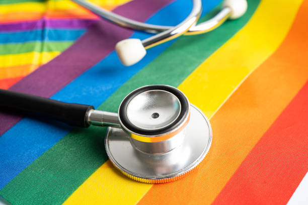 Black stethoscope on rainbow flag background, symbol of LGBT pride month  celebrate annual in June social, symbol of gay, lesbian, bisexual, transgender, human rights and peace. stock photo