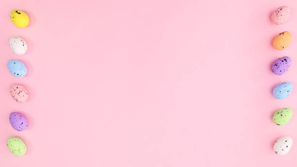 istock Easter bright pink background with colorful eggs on left and right side. Copy space creative composition. 1372364747