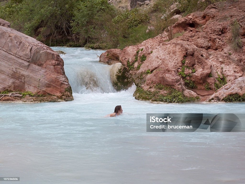 Woman Swimming Woman swimming in the turquoise waters of Havasu Creek, Grand Canyon. Activity Stock Photo