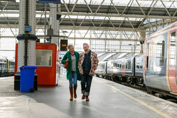 istock Vibrant senior couple walking on train station platform 1372365337