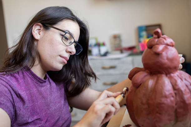 istock Young woman working on a sculpture 1372365573