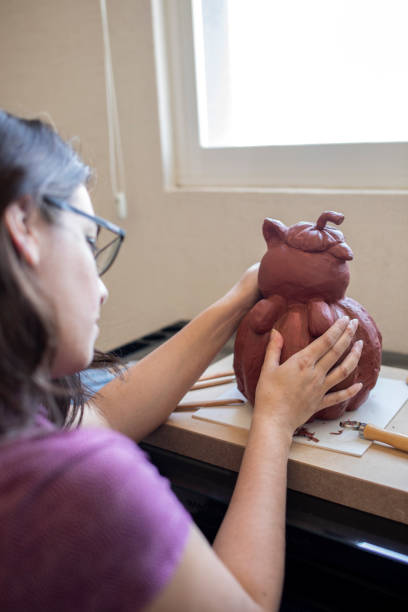 istock Young woman working on a sculpture 1372365600