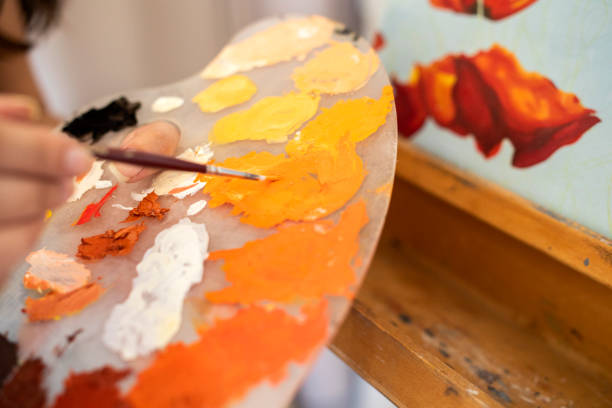istock Young woman working on a painting 1372366550