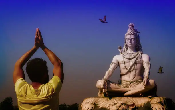 Shivratri and Shiva A man soing Namskara to Shiva Statue