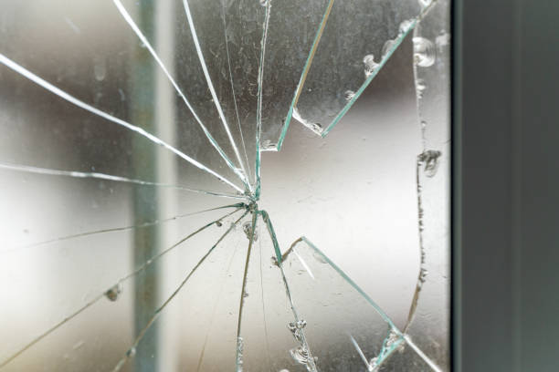 istock Glass broken by hooligans in a metal-plastic window, close-up 1372368518