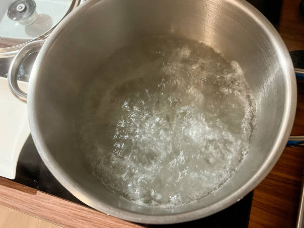 istock Boiling water in a large iron pot. 1372373741