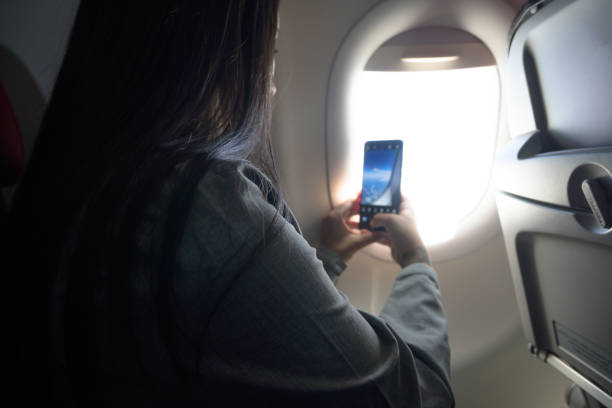 istock A woman taking a picture through the plane window 1372373962