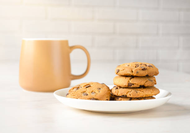 istock Morning rays, cookies and tea for breakfast in brown cup 1372376339