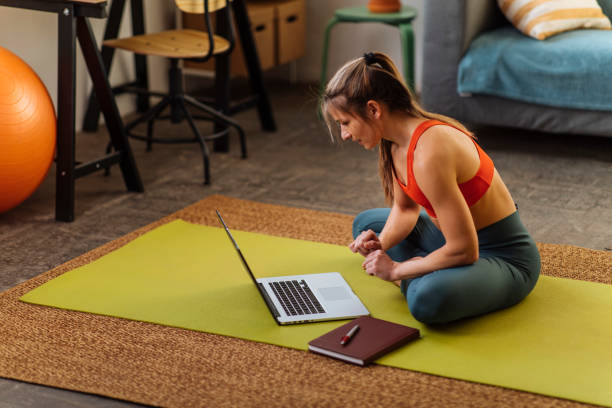 istock Young woman using laptop on floor 1372376502