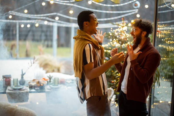 istock Two male friends celebrating with sparklers at backyard 1372376520
