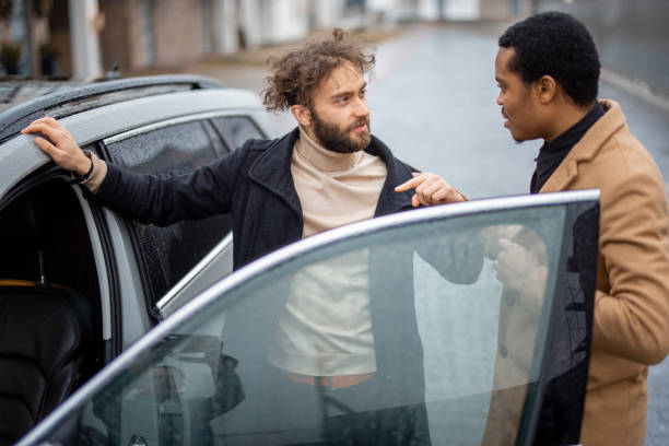 istock Two men flirting while standing near car on the street 1372376706